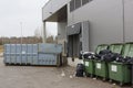 Garbage dump and containers near shop