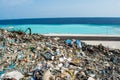 Garbage dump near the beach close to ocean full of smoke, litter, plastic bottles,rubbish and trash at tropical island Royalty Free Stock Photo