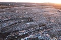 Garbage dump with waste plastic, polyethylene and food waste. Trash disposal for recycling and re-use. Bulldozer at landfill