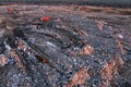 Garbage dump with waste plastic, polyethylene and food waste. Trash disposal for recycling and re-use. Bulldozer at landfill