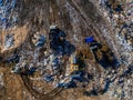 Garbage dump and working dump truck and bulldozer, aerial top view