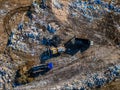 Garbage dump and working dump truck and bulldozer, aerial top view Royalty Free Stock Photo