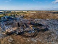 Garbage dump and working dump truck and bulldozer, aerial view