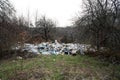 Garbage in the forest. People illegally throwing garbage into the forest. Illegal garbage dump in nature