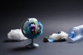 Garbage globe on a dark background as a symbol of environmental pollution with plastic and hazardous waste. Royalty Free Stock Photo