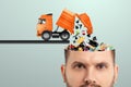 Garbage in the head, clogging up the head with unnecessary information. Garbage truck unloads garbage into the head Royalty Free Stock Photo