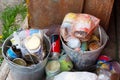 Garbage. household waste. garbage in a metal bucket outdoors in the yard.