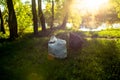 Garbage left by vacationers on the shore of the lake in the grass in plastic garbage bags. Pollution of nature. Non