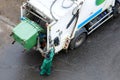 Garbage man operating garbage truck in residential area, everyday garbage removal