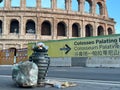 Garbage in and next to the trash can at the Colosseum in the Italian capital of Rome