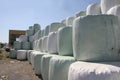 Garbage. Packing bales with garbage with tractor machines, place for making bales with garbage, Wrapped stacked bales