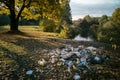 Garbage pile in forest. Rubbish heap after picnic near river. Environmental pollution. Ecological issue.