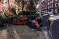 Garbage piled against the public dumpster