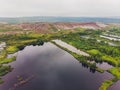 Garbage and reflection of the leafless trees in water. Environmental pollution. Water pollution. Royalty Free Stock Photo