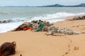 Garbage on sea beach, dirty ocean water, environmental pollution, ecology, waste, rubbish, plastic, trash, refuse, litter Royalty Free Stock Photo