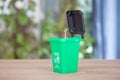 In the garbage sorting, the model of the green trash can containing kitchen waste opens the lid to grow buds