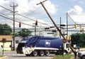 Garbage truck hit a pole knocking it on the truck