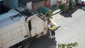 Garbage truck is loading waste automatically, shifting dumpster