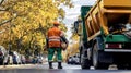 Garbage truck unloading trash at landfill site under cloudy sky Royalty Free Stock Photo