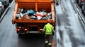 Garbage truck unloading trash at landfill site under cloudy sky Royalty Free Stock Photo