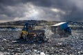 Garbage truck unloading waste on landfill, environmental concept. Royalty Free Stock Photo