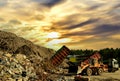 Garbage truck unloads construction waste from container at the landfill. Recycling waste concrete and demolition material.