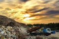 Garbage truck unloads construction waste from container at the landfill. Recycling waste concrete and demolition material.