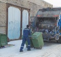 Of a garbage truck worker prepares barrels of garbage Royalty Free Stock Photo