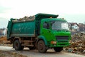 Garbage trucks at work, emptying waste containers for proper disposal