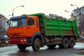 Garbage trucks at work, emptying waste containers for proper disposal