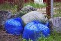 Garbage and waiste in black and blue polyethylene bags. Environmental protection concept Royalty Free Stock Photo