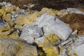 Garbage from white bags and pieces of yellow glass wool