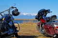 Harley Davidson motorcycles with snow covered mountains in fall