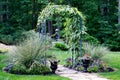 Garden arbor leading to forest path Royalty Free Stock Photo