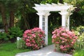 Garden arbor and pink flowers. Royalty Free Stock Photo