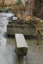 Garden in autumn in rain and stone accessories