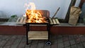 Garden Barbeque with fire getting ready to cook meat for a home party. Flame in bbq. Hot Charcoal and wood