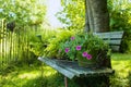 Garden bench with flowers on a tablett