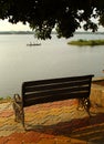 Garden bench on the rural lake shore