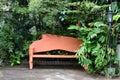 GARDEN BENCH WITH VEGETATION AND FLOWERS AROUND ROMANTIC AND QUIET PLACE Royalty Free Stock Photo