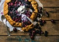 Garden berry crostata sweet pie with melted vanilla ice-cream scoop