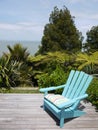 Garden: blue chair on wooden deck Royalty Free Stock Photo