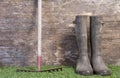 Garden boots and rake on grass Royalty Free Stock Photo