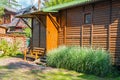 Garden building with a canopy bench and a street lamp in the country. Bushes in the foreground. In the background are red currant Royalty Free Stock Photo