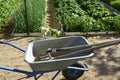 Garden cart close up. Transporting manure, earth and grass in a cart in the garden. Agricultural work. garden cleaning equipment Royalty Free Stock Photo