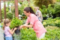 Garden center child mother shopping flowers plant