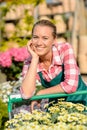 Garden center smiling woman worker with cart Royalty Free Stock Photo