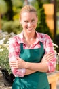 Garden center smiling woman worker wear apron Royalty Free Stock Photo