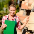 Garden center woman by clay pots shelf