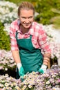 Garden center woman in flowerbed smiling Royalty Free Stock Photo